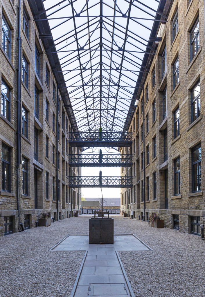 The full-height glass atrium at the heart of Conditioning House